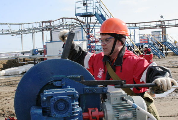 оператор по добыче нефти М. Садреев выполняет операцию по спуску скребка в скважину